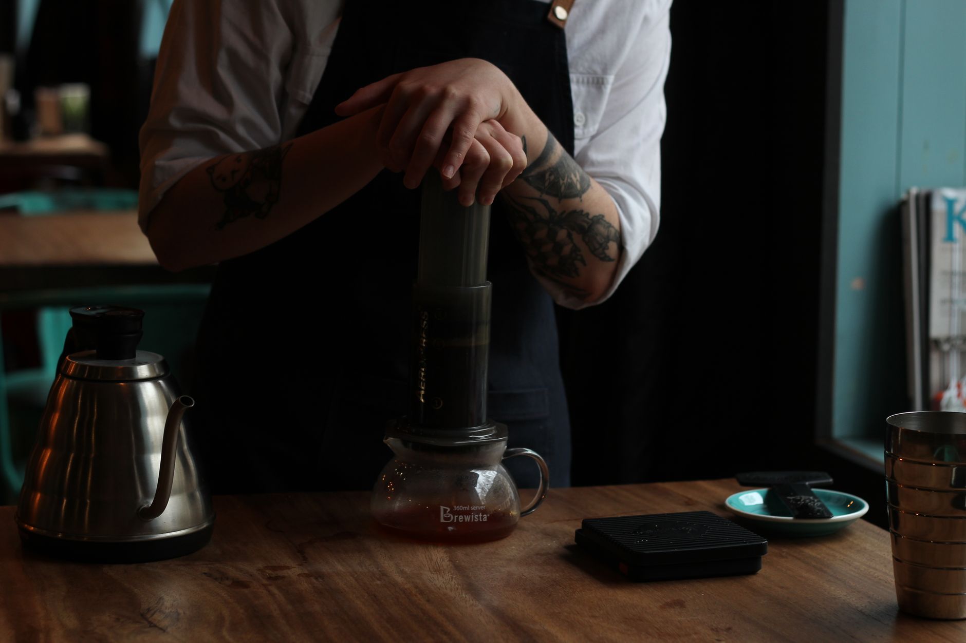 aeropress pressing coffee into white ceramic mug kitchen