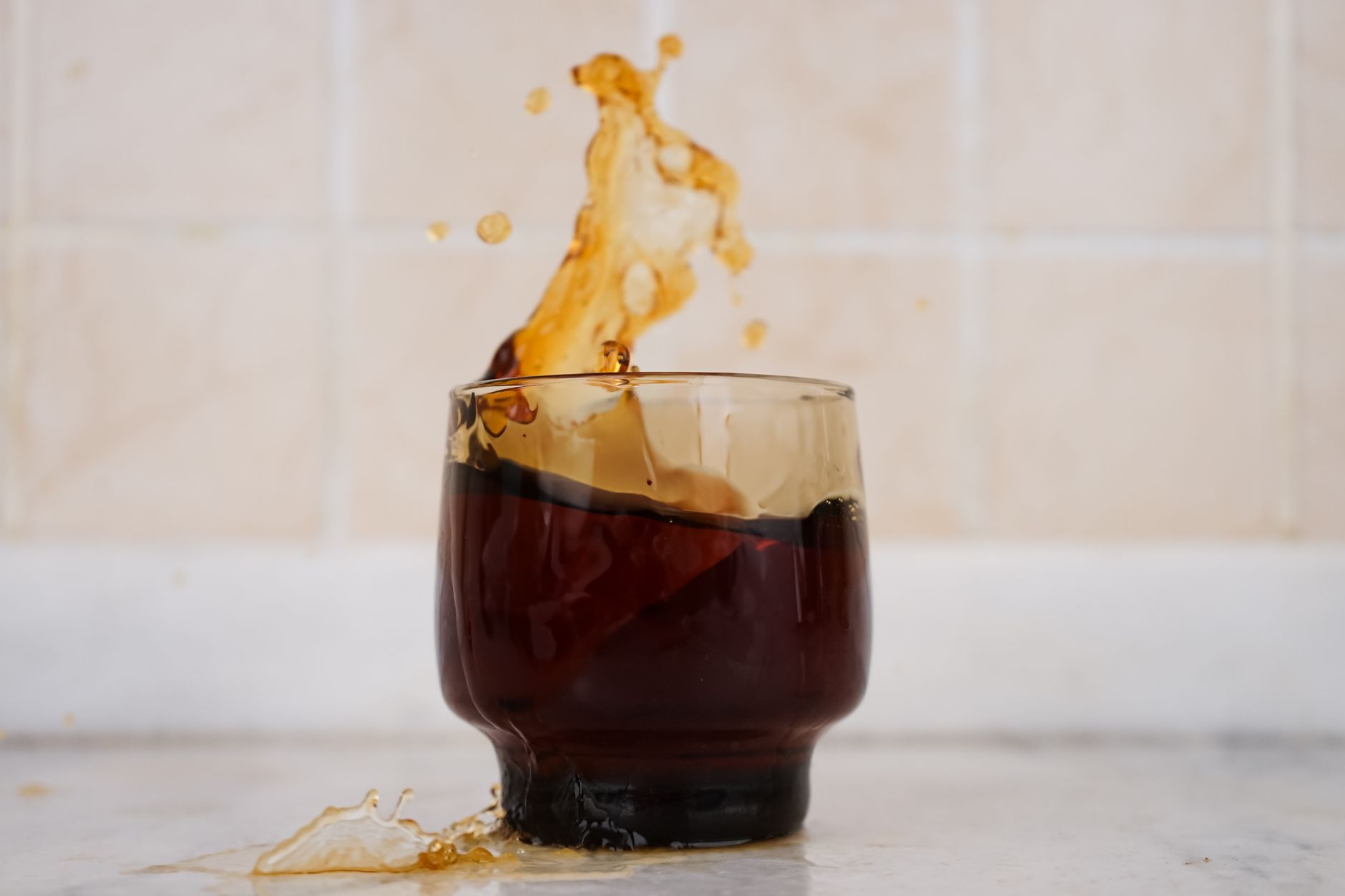 aeropress cold brew concentrate pouring over ice glass