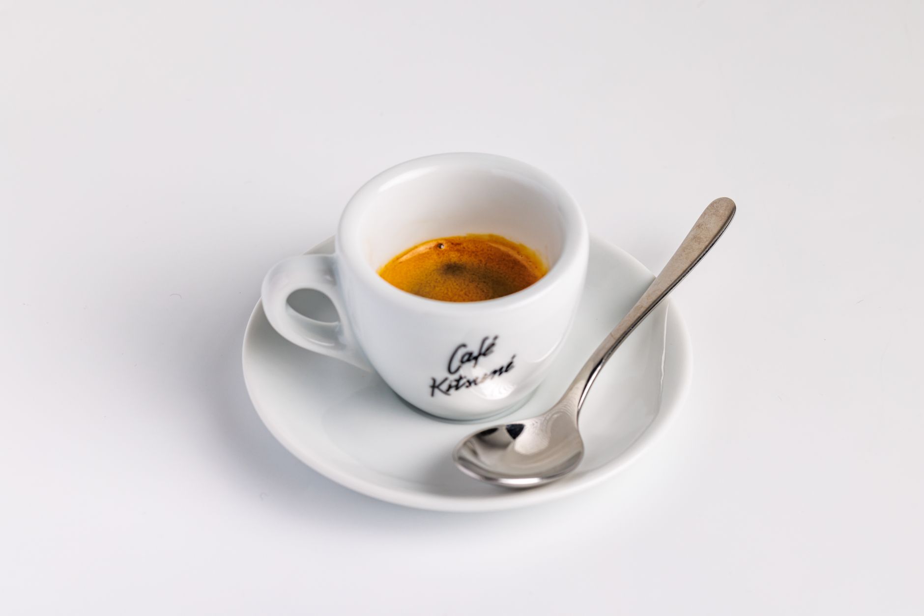 traditional espresso demitasse cup with golden crema on marble bar