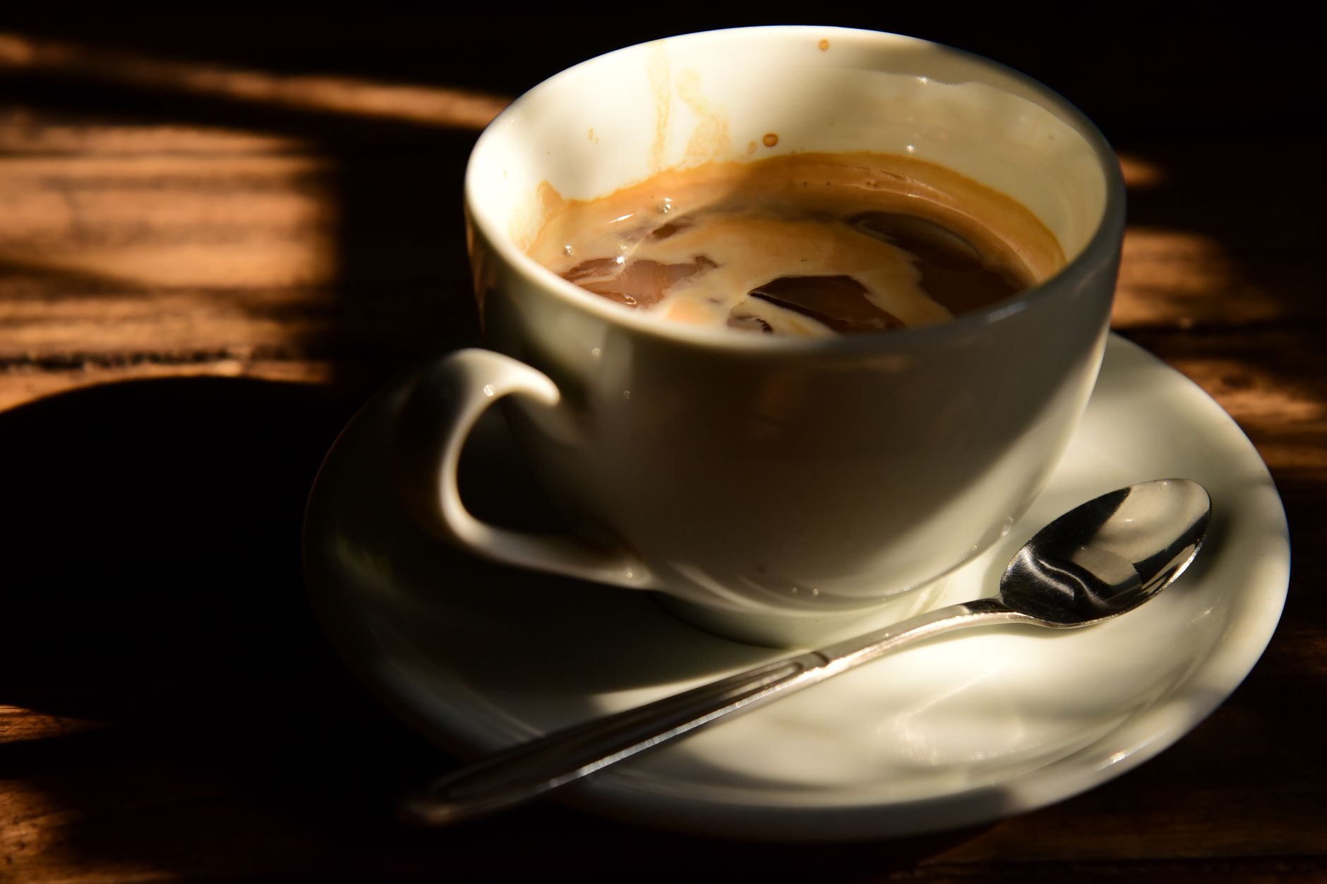 espresso shot golden crema in white demitasse