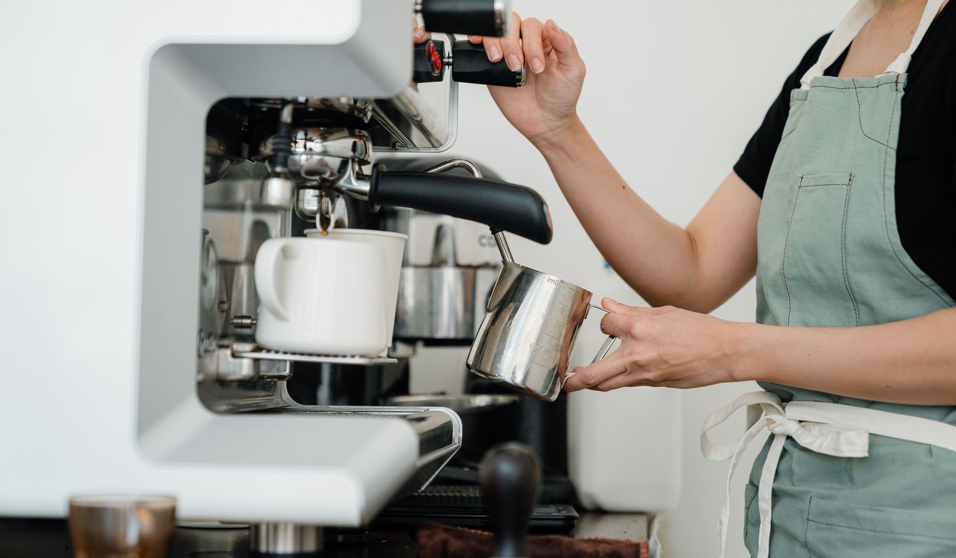 Semi-automatic espresso machine pulling a shot with crema