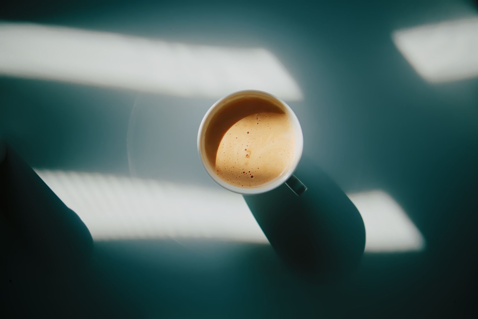 espresso shot golden crema in white demitasse cup