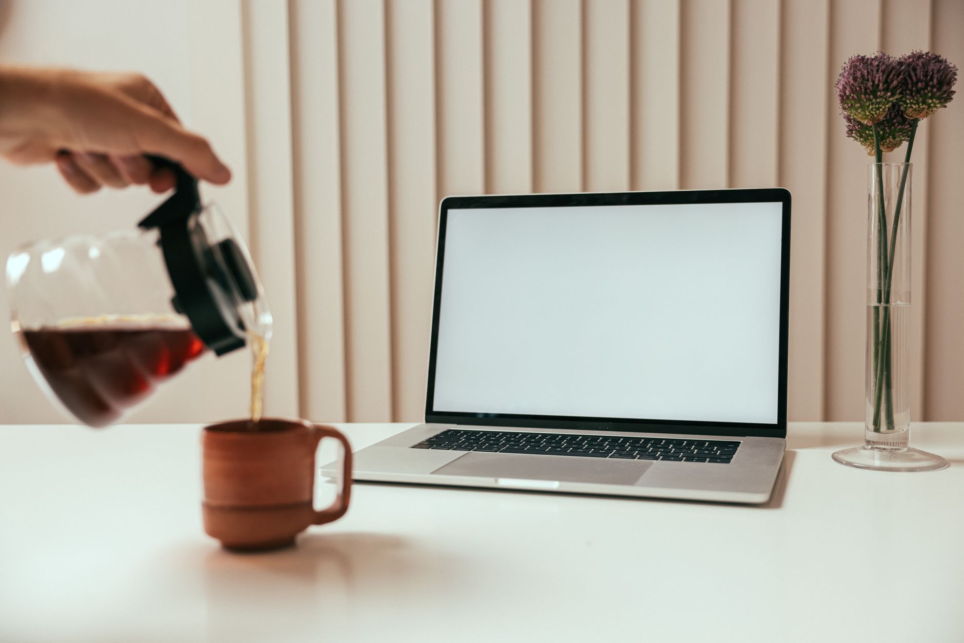 french press coffee being poured into white ceramic mug