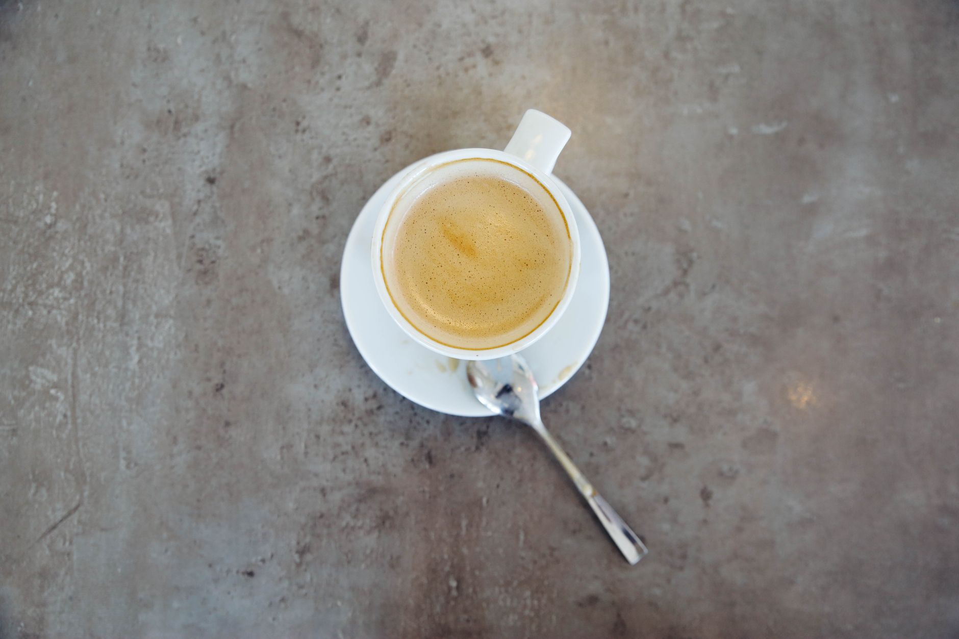 espresso shot golden crema in white demitasse cup