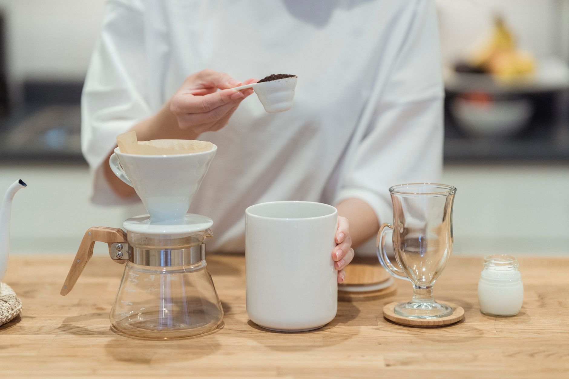 handheld frother frothing milk in glass jar warm foam