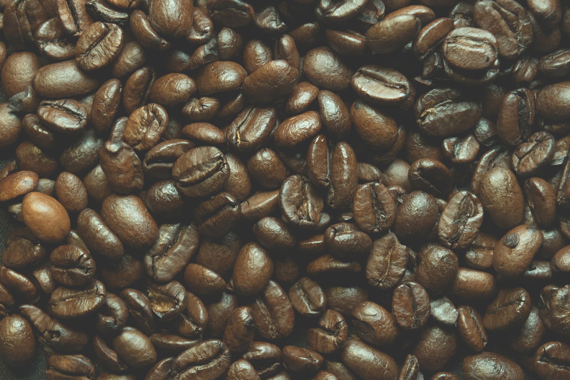 green coffee beans spread on burlap sack
