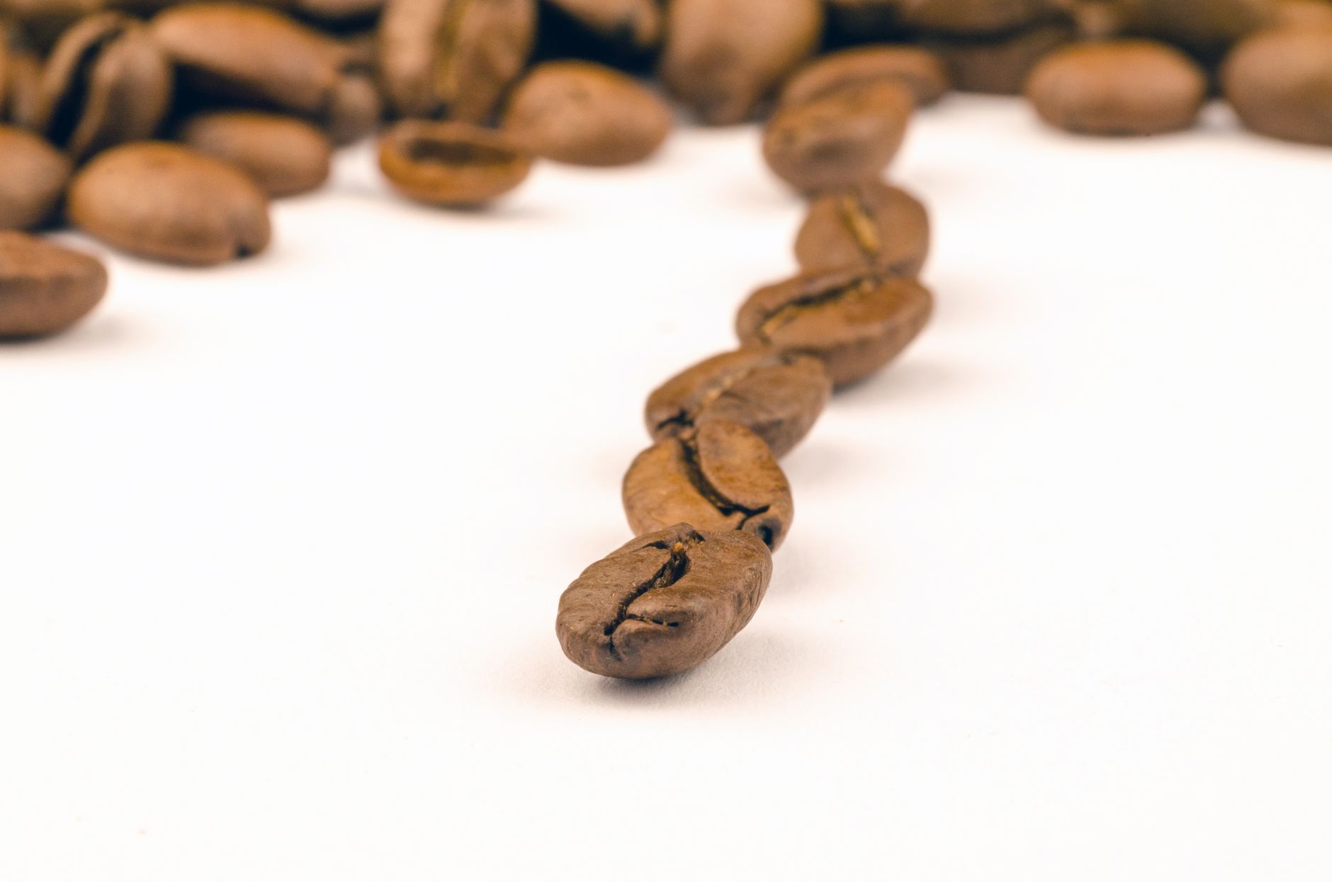 roasted whole coffee beans in open kraft valve bag