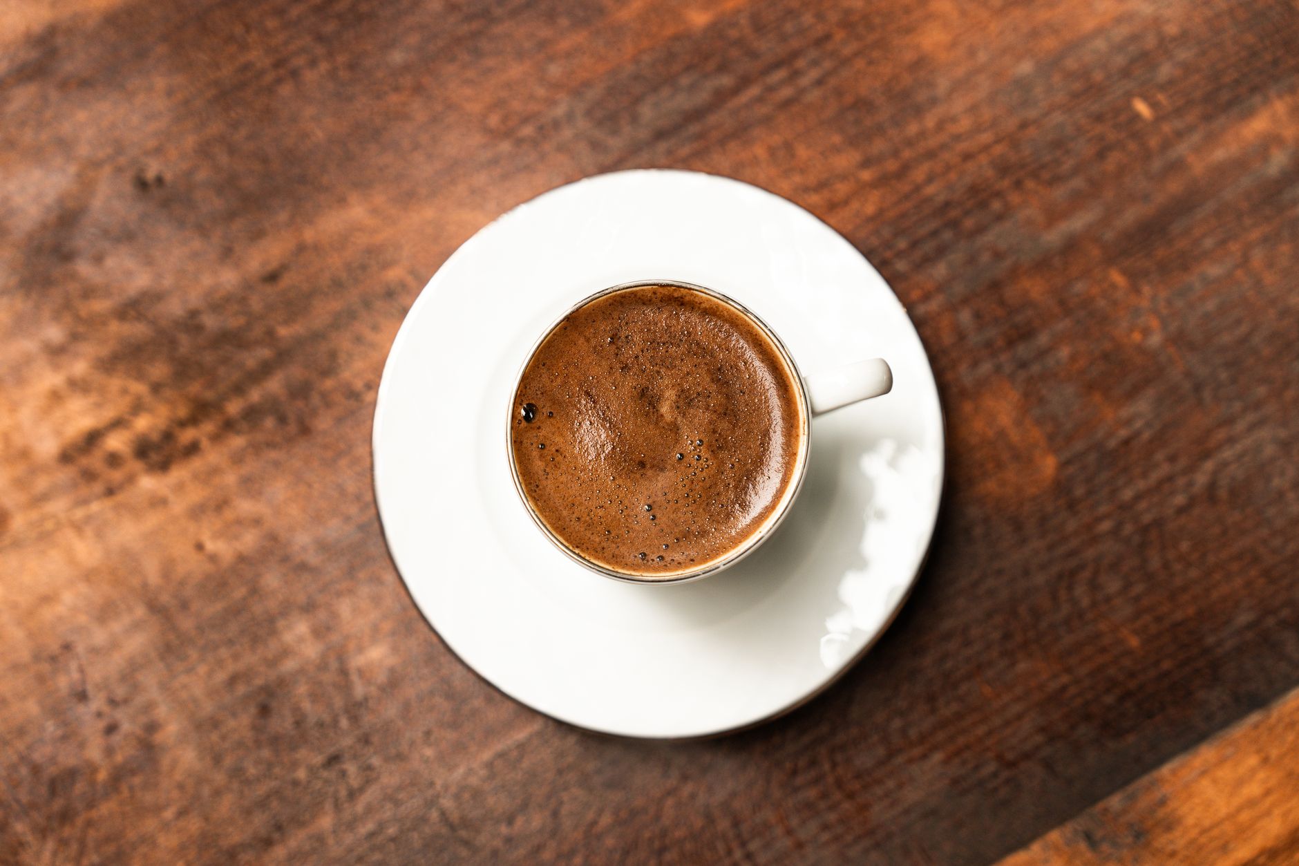 espresso shot golden crema in ceramic demitasse