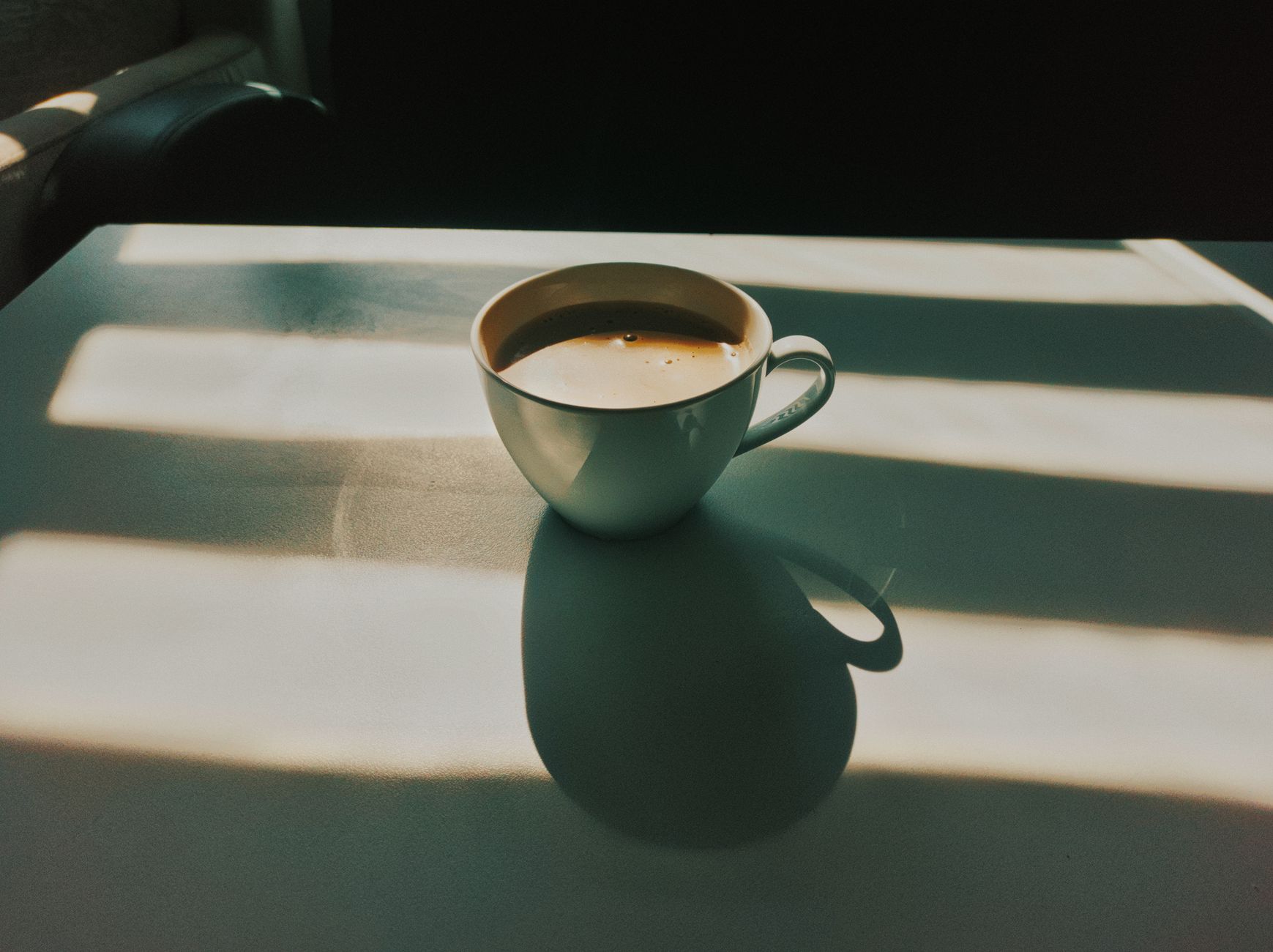 dark roast espresso shot golden crema in white ceramic cup