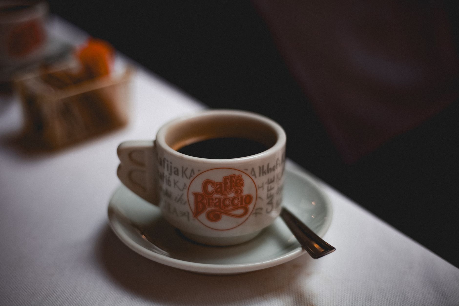 dark espresso ristretto shot in small demitasse cup crema