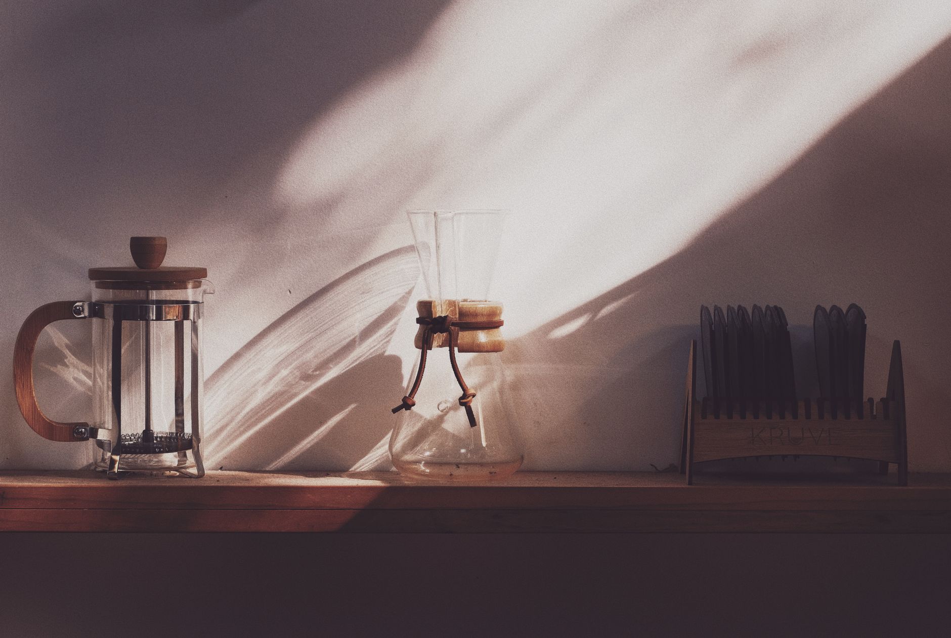 chemex glass carafe paper filter coffee pouring sunlight